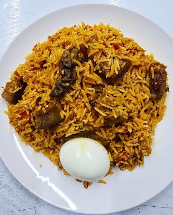 Party jollof rice with assorted meat and a boiled egg